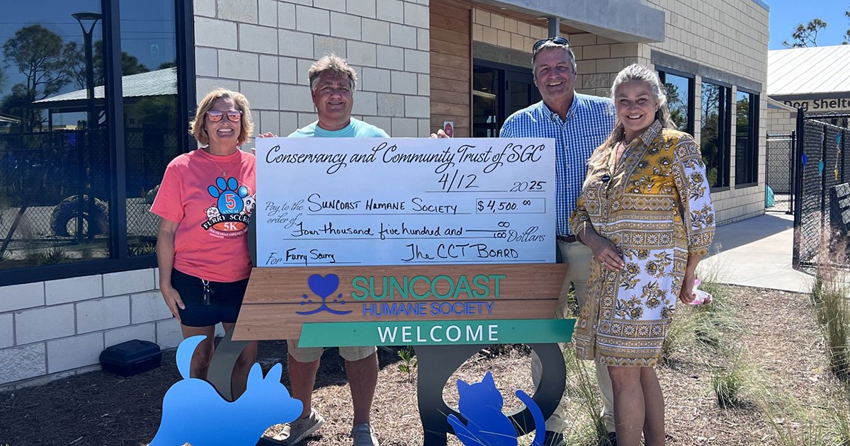 Board President Jeff Moore and Chief Executive Officer Maureen O'Nell receiving large donation check
