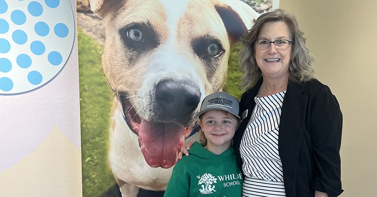 young Mason with his generous gift of toys, puppy pads, and cash, standing with Suncoast Humane Society's Christine Varcoe