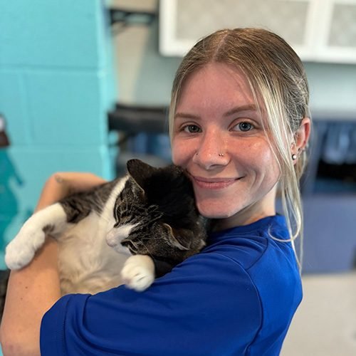 Anna holding a gray and white cat